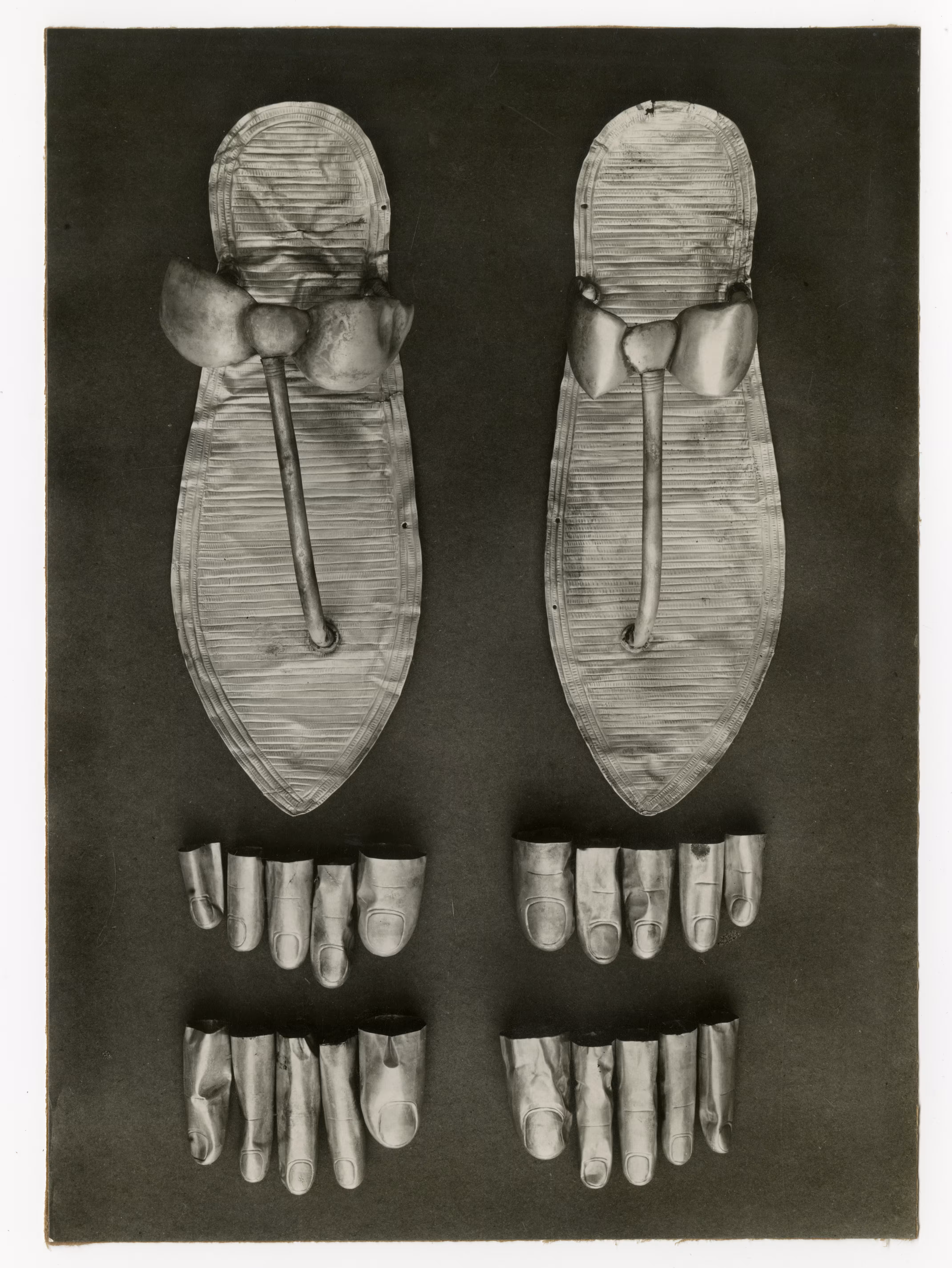 Image of photographic print of a pair of sandals and toe and finger stalls