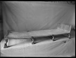 Image in negative of a bed with lion forepart's as legs