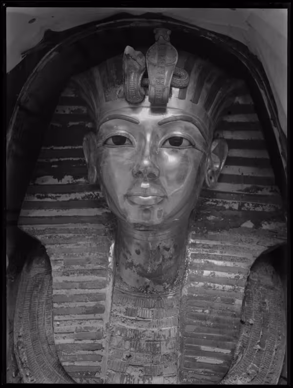 Image of gold mask of king within coffin negative