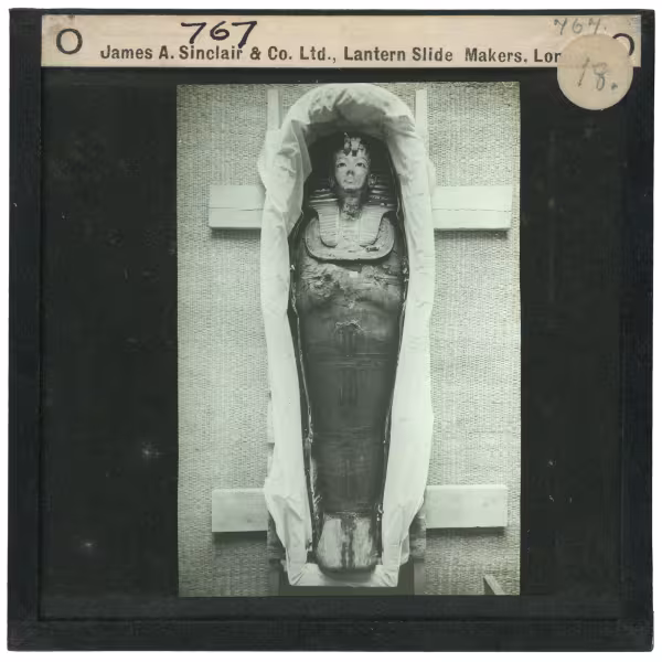 Image of lantern slide of mummy lying in coffin