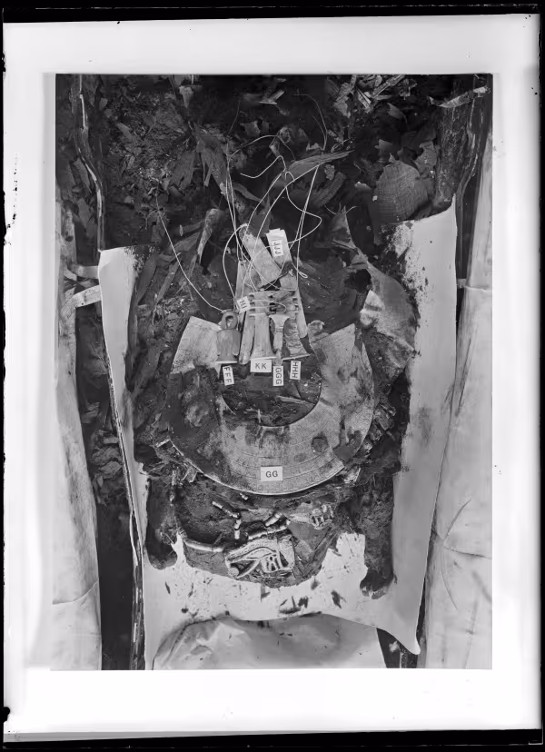 Image of assorted amulets and jewellery among the wrappings of the king's mummy negative