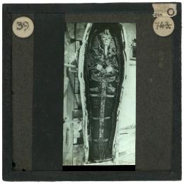 Image of lantern slide of mummy lying in coffin