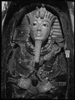 Image of gold mask of king within coffin negative