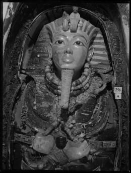 Image of gold mask of king within coffin negative