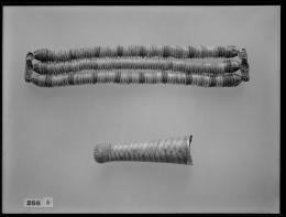 Image of beaded necklace and a straight beard attachment negative