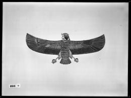 Image of a pectoral of a human-headed bird with outstretched wings negative