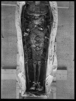 Image of negative of the king's mummy showing objects found in wrappings