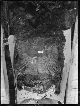 Image of negative of middle of king's mummy showing assorted objects