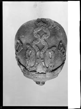 Image of negative of top of king's head disattached from mummy, showing beaded snake patterns