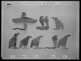 Image of negative of various flat golden amulets