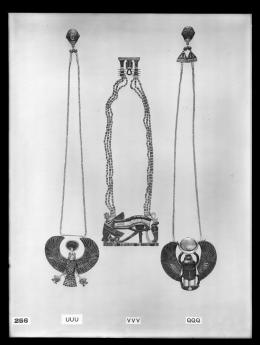 Image of negative of three necklaces: the left one with a falcon, the middle one with a vulture, eye and cobra, and the right one with a winged scarab