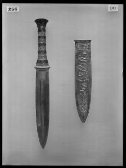 Image of negative of dagger with decorated handle and embossed dagger sheath