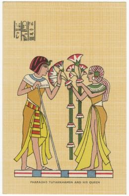 Postcard labelled “Pharaohs Tutankhamen and His Queen”. It depicts an idealised scene in which Tutankhamun, standing on the left, faces his queen Ankhsenamun, who offers lotuses to her husband. Three lines of decorative faux hieroglyphs appear in the upper left corner.